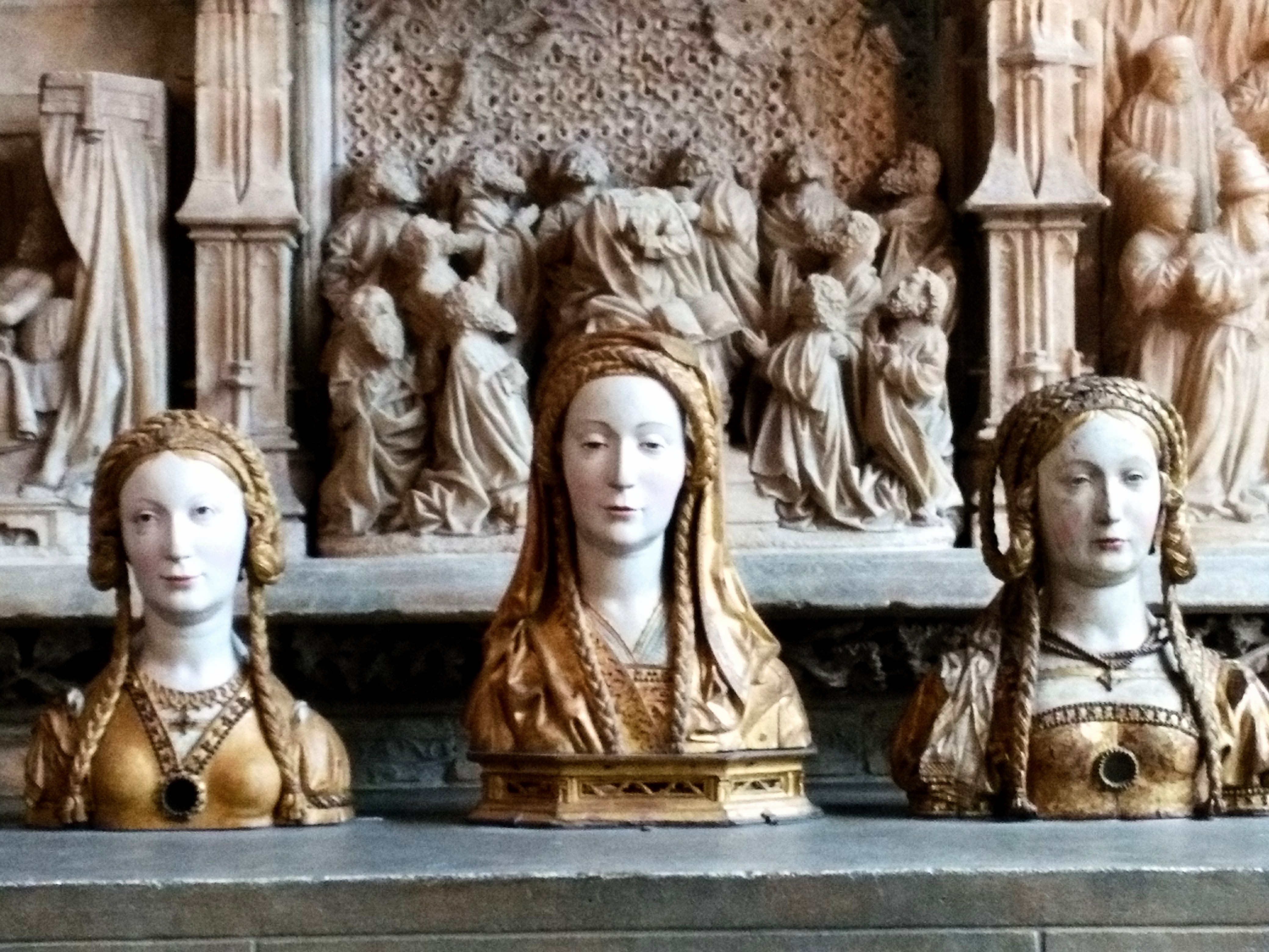 Three busts of women with braided crowns.