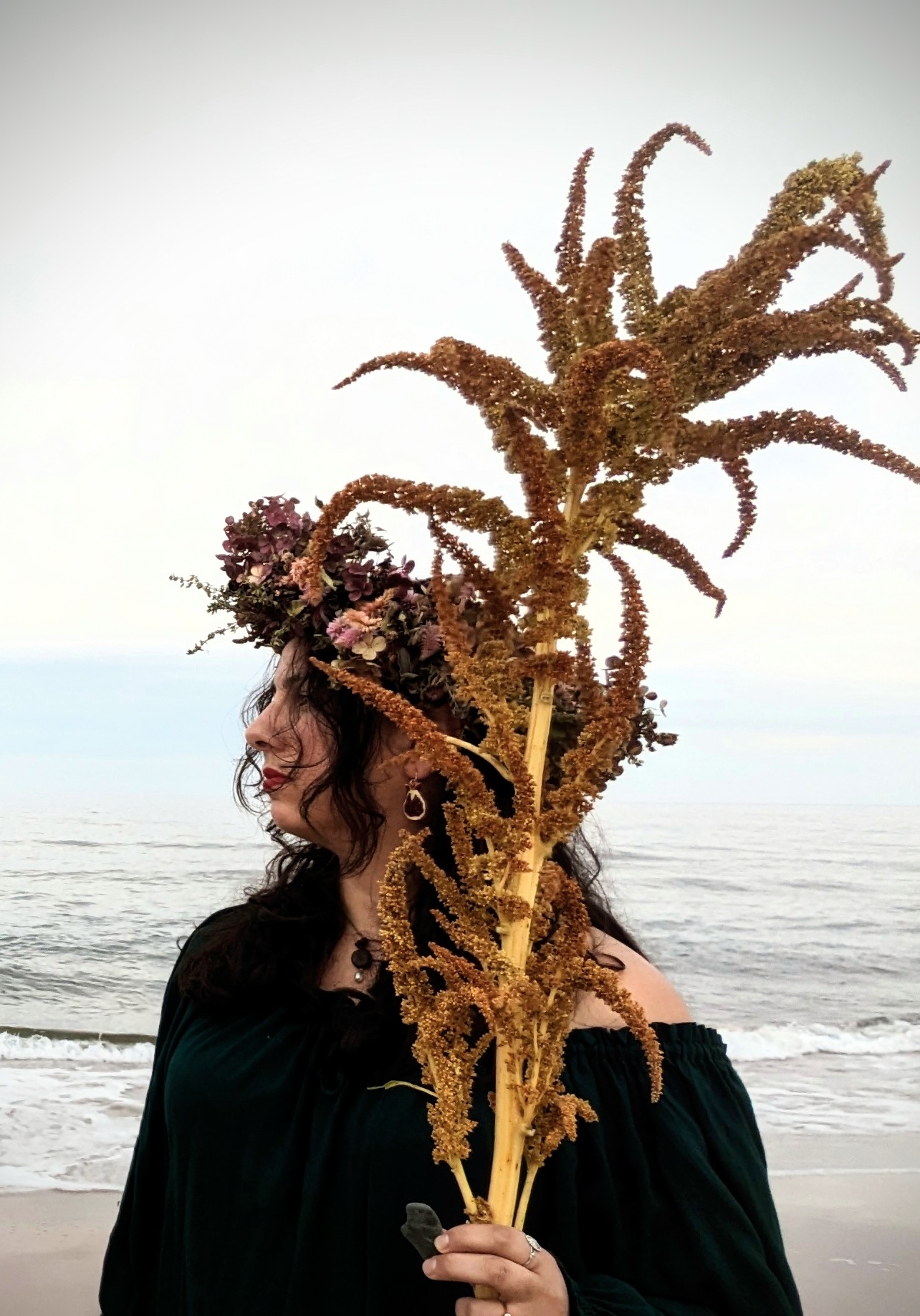 Amal wearing a crown on the beach.