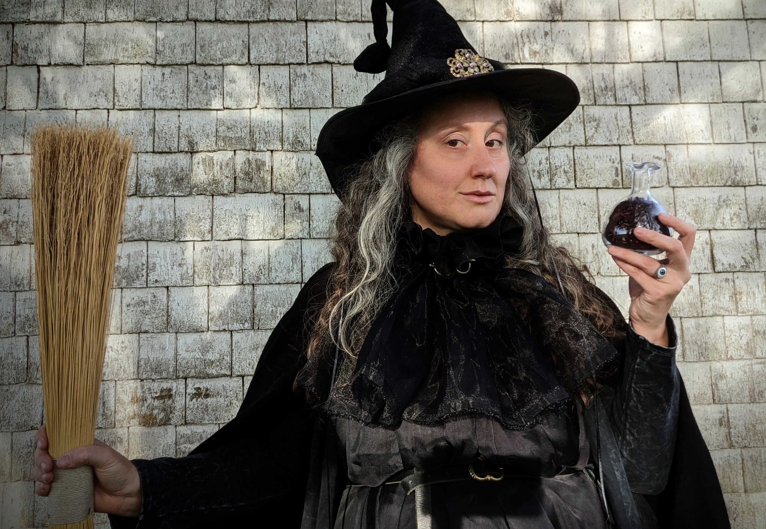 A witch offers a potion.