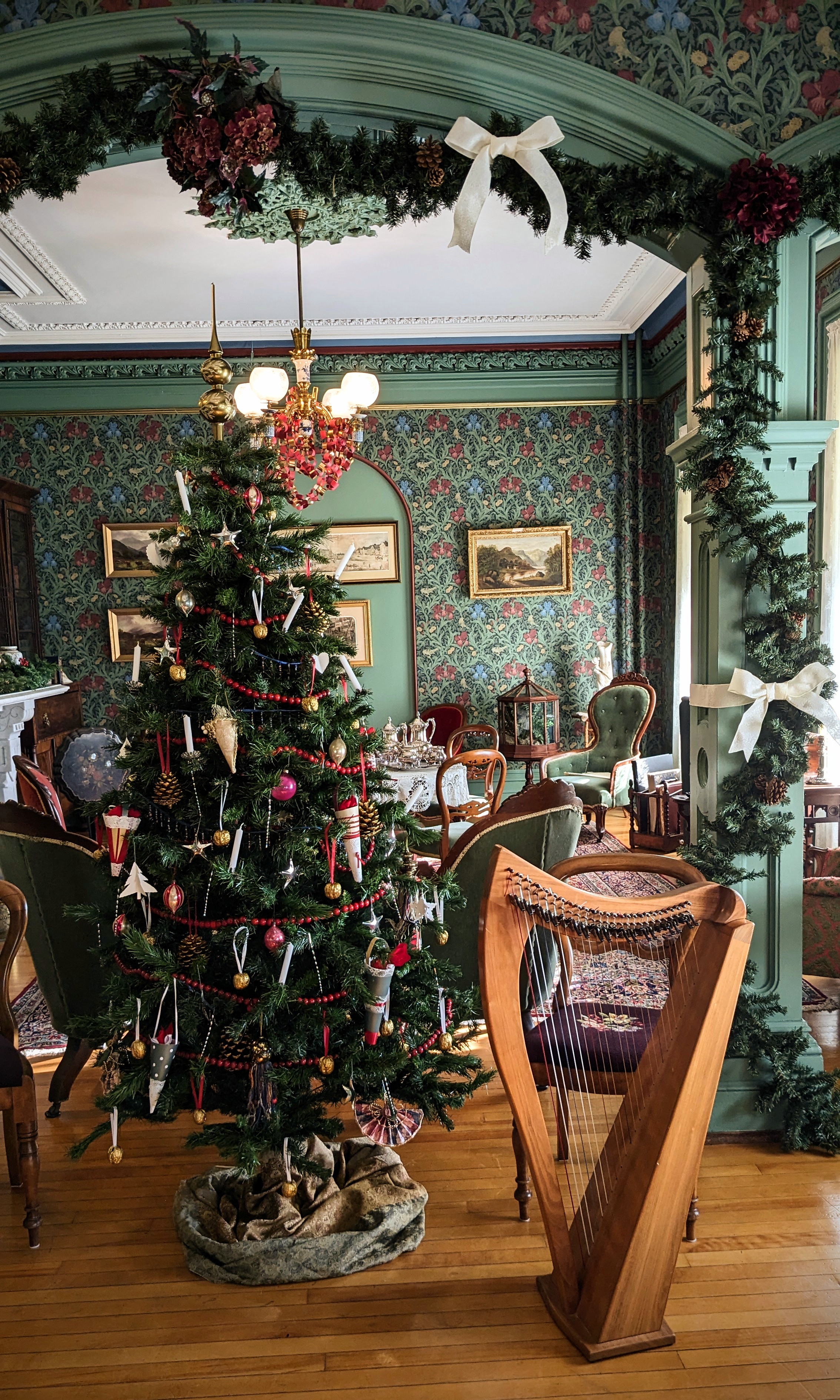 A Christmas tree and harp in the drawing room. 